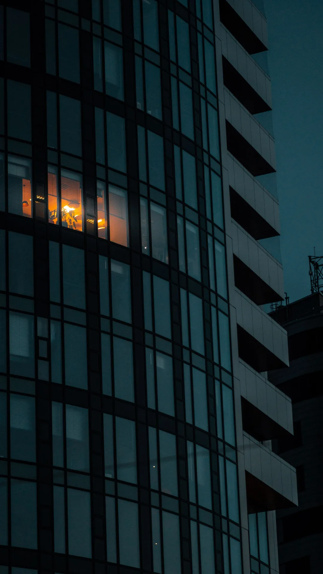 Illuminated office building representing an independent service business